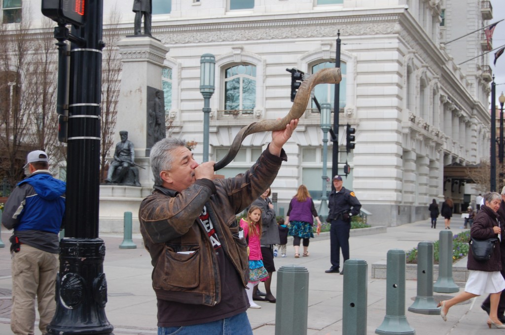 An anti-Mormon protester blows on the ram's horn, or shofar, at the southeast corner of Temple Square.